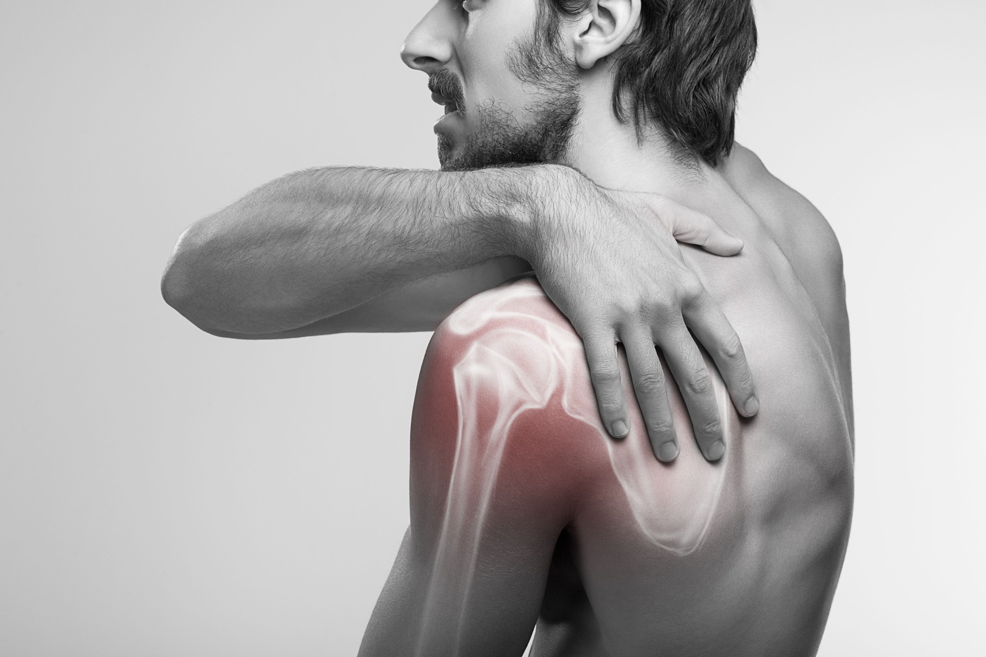 Shoulder pain. Man holding a hand on shoulder