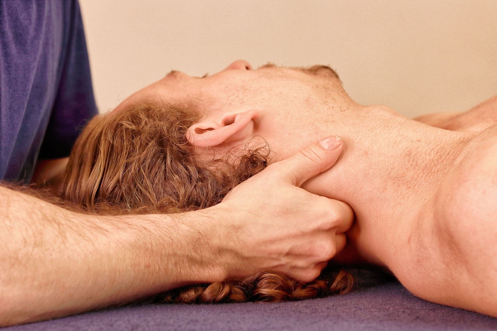 A Massage Therapist Doing Front, Neck And Shoulder Massage To A Male Patient In A Massage Studio